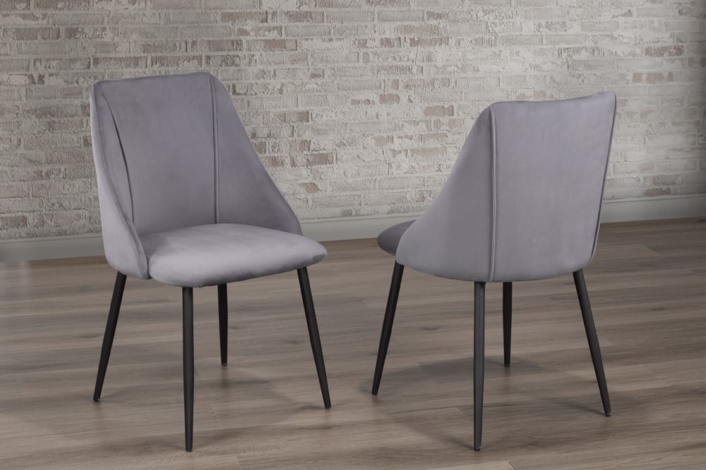 Grey velvet dining chair with cushioned seat and back