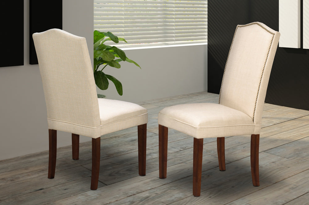 Beige linen dining chair with brass nailhead trim and walnut wood legs