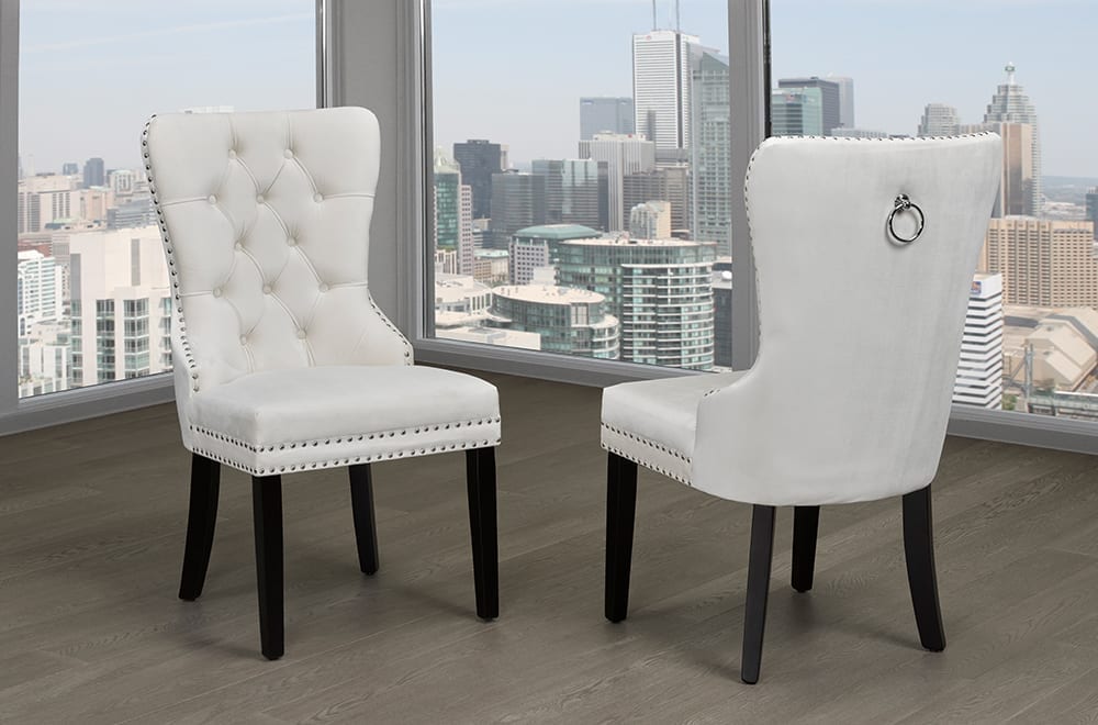 Velvet dining chair with button tufting, nail-head trim, and chrome knocker – Cream